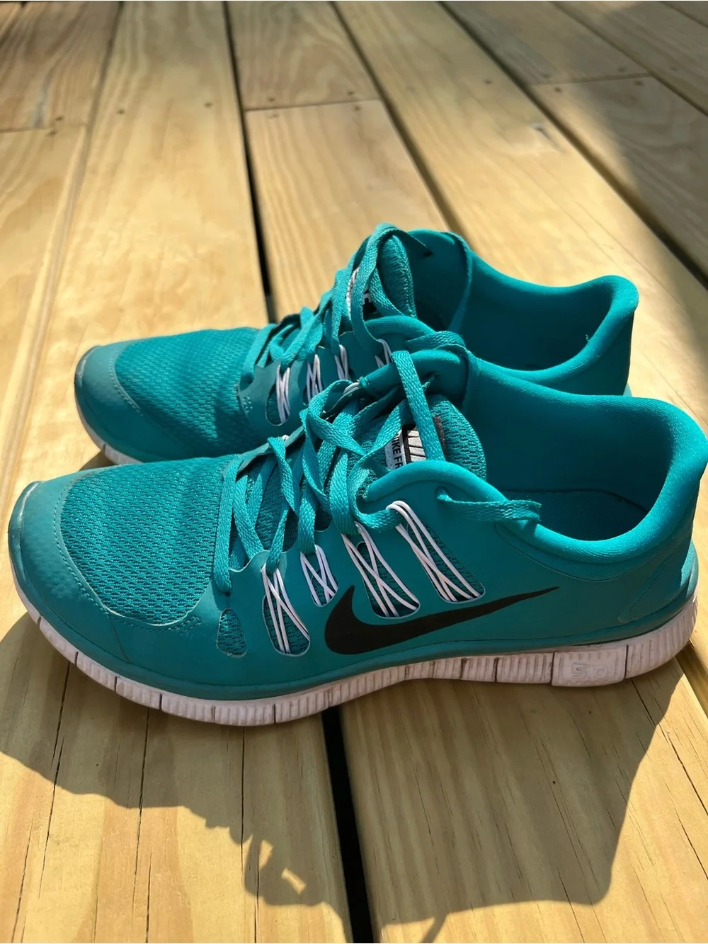 Nike Women’s Teal Athletic Running Shoes with Black Swoosh. Nike Free 5.0